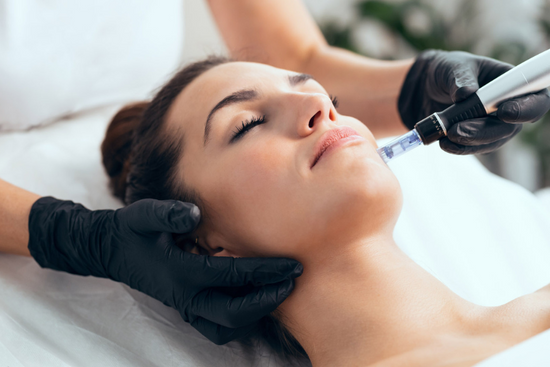 A woman enjoying a facial treatment at Colorado Beauty RN.