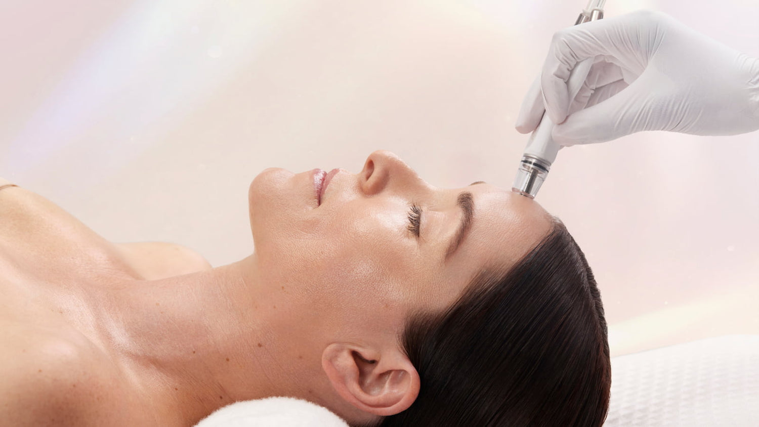 a person receiving a diamond glow treatment